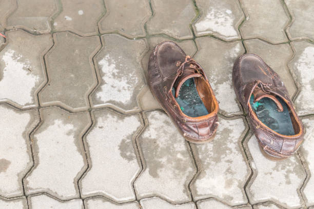 istock pair of old brown leather shoes on cement background 928453082