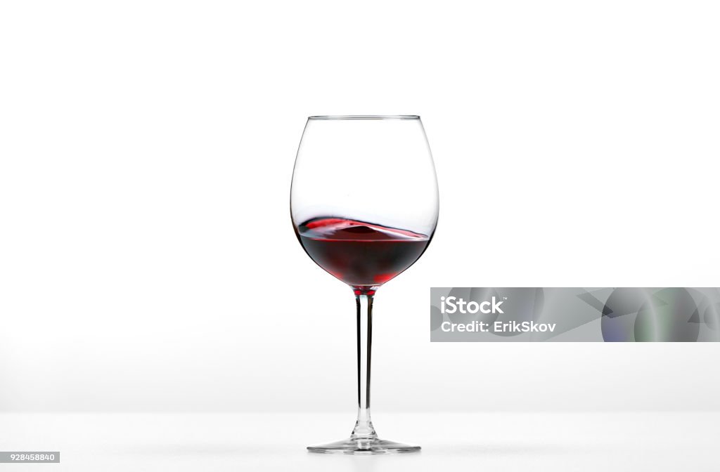 Rolling red wine Rolling red wine on white background. Wineglass Stock Photo