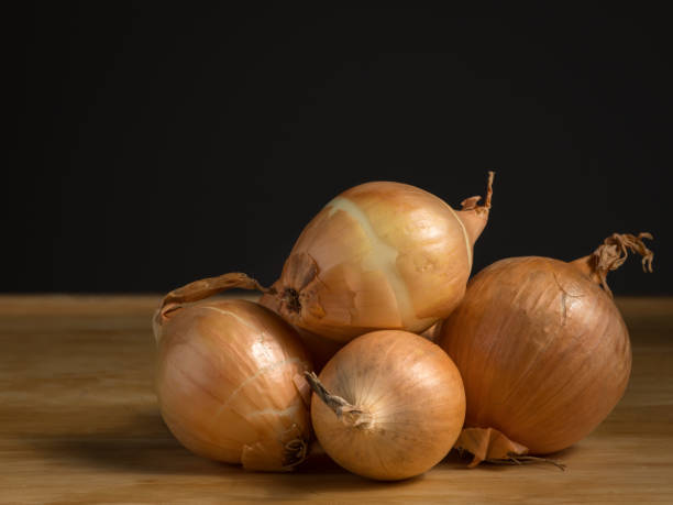 istock A pile of fresh onions lying on a table 928458970