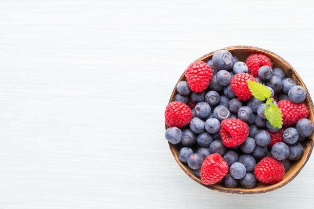 istock Juicy and fresh blueberries with green mint on rustic blue table. 928461764
