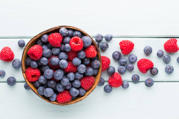 istock Juicy and fresh blueberries with green mint on rustic blue table. 928466096