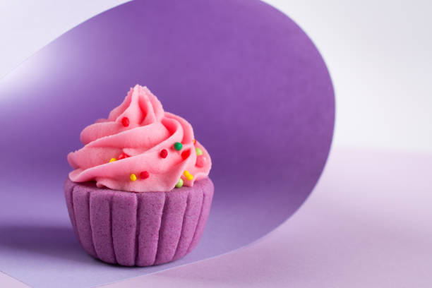 istock Purple decorative  sugar  cupcake on light background with sprinkles 928466206