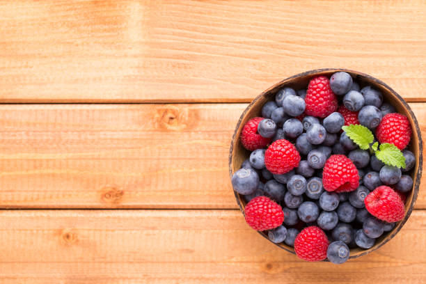 istock Juicy and fresh blueberries with green mint on rustic blue table. 928469290
