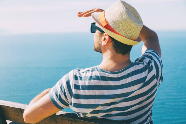 istock Man sitting on the bench and enjoying the view. 928469670