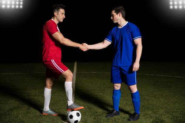 istock Players handshake at soccer field center 928470194