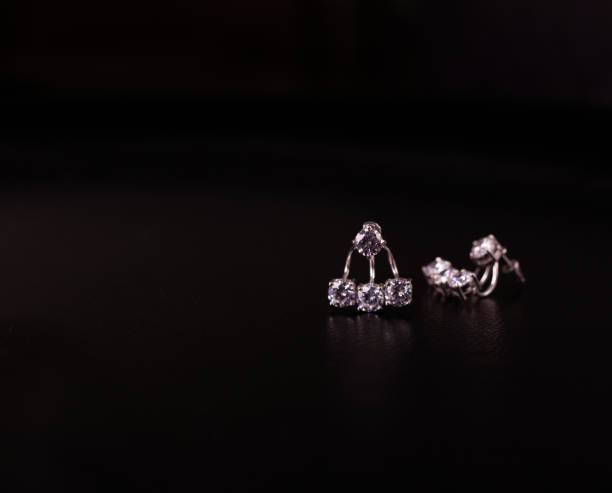 istock Fine silver jewelry on a black background with copy space 928470274