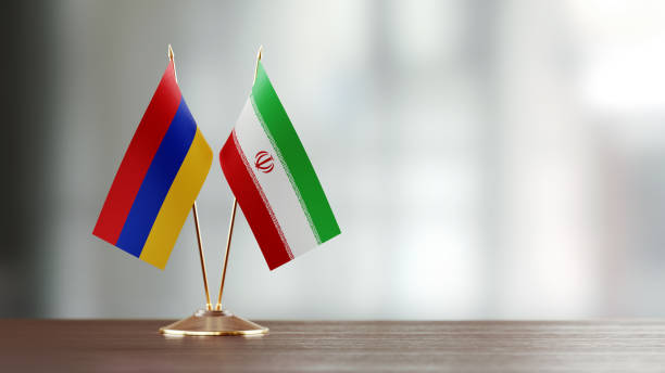 istock Armenian And Iranian Flag Pair On A Desk Over Defocused Background 928470278
