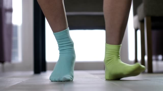 Female feet dancing in mismatched socks