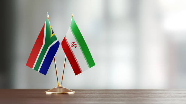 istock South African And Iranian Flag Pair On A Desk Over Defocused Background 928473122