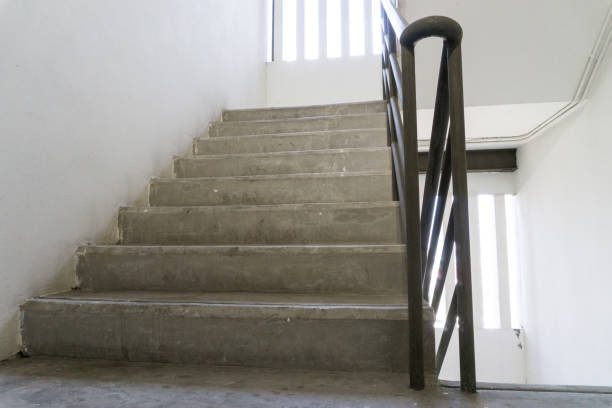 istock Old staircase with a handrail in a building 928474570