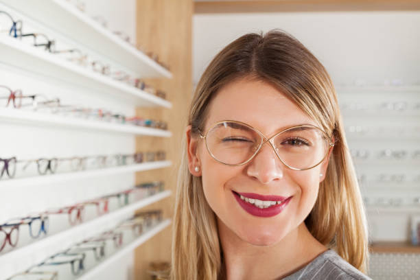 istock Woman choosing eyeglass frame, wink 928477100