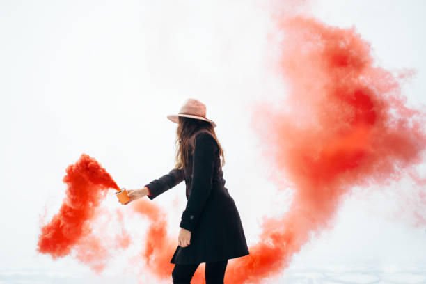 istock Hipster woman with red smoke 928477180