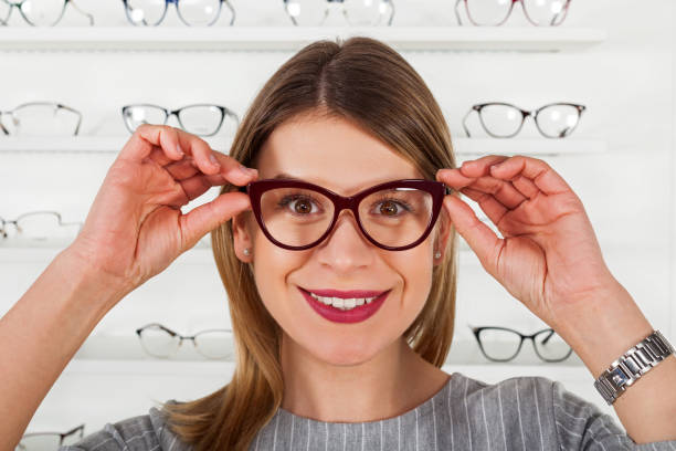 istock Young woman choosing eyeglass frame 928477436