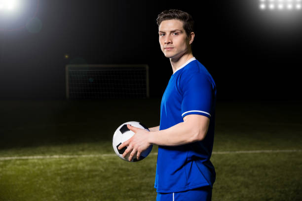 istock Football player on the field with ball 928477800