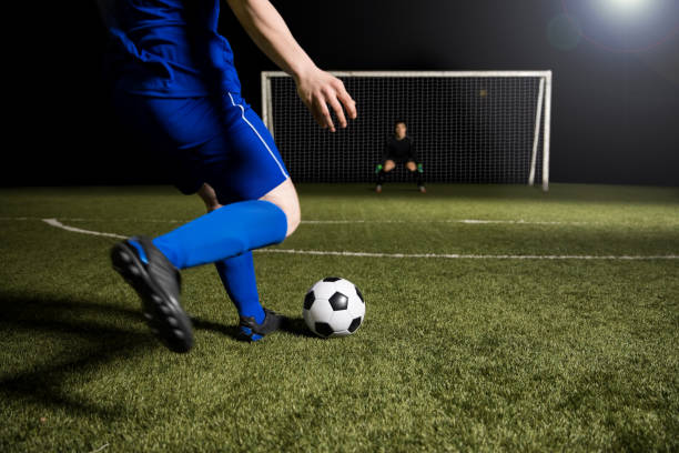 istock Soccer player making a kick towards the goal 928478018