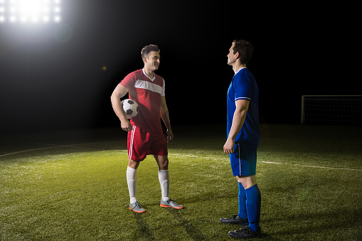 Two footballers talking with each other after the world cup game at stadium