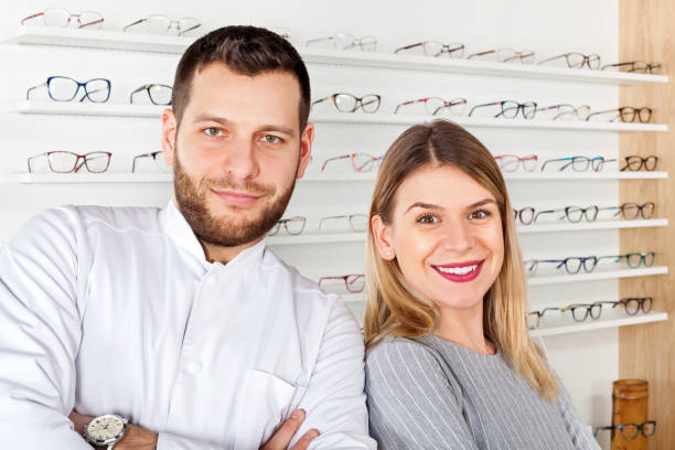 istock Ophthalmologist and beautiful patient in optical store 928482018