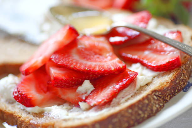 istock Fresh strawberries with cream cheese on bread 928483732