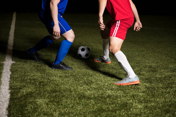 istock Footballers with ball in action 928483890