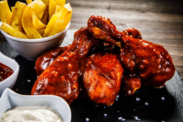 istock Fried chicken drumstics with French fries 928488960