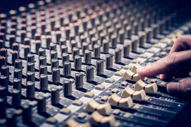 istock male sound engineer hands working on audio mixing console 928489414