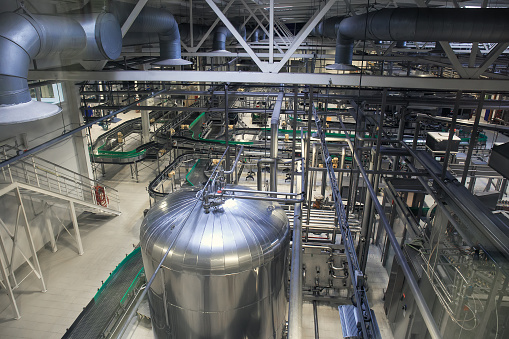 Brewery production line, steel tanks or vats for beer fermentation and manufacturing, pipelines and modern machinery equipment