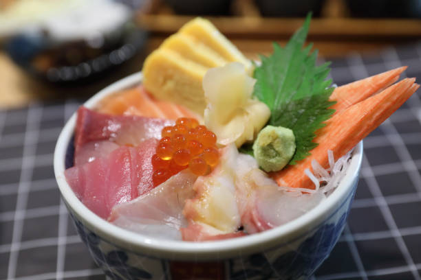 istock Kaisendon sushi don on rice with wood background 928498256
