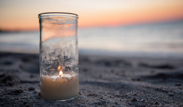 istock Candle on the Beach at Sunset 928498368