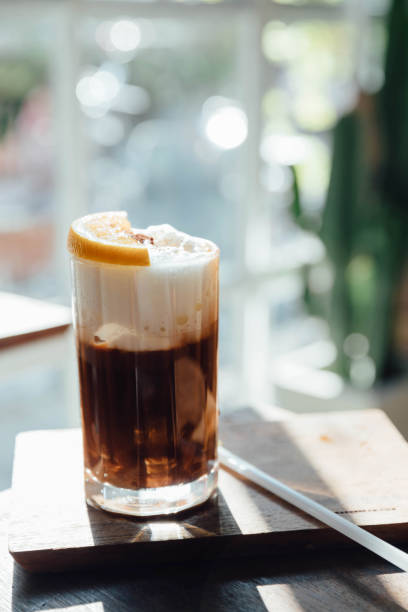 istock Ice black coffee with orange on wood background 928498404
