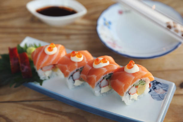 istock Sushi rolls with salmon on top , Japanese cuisine 928498598