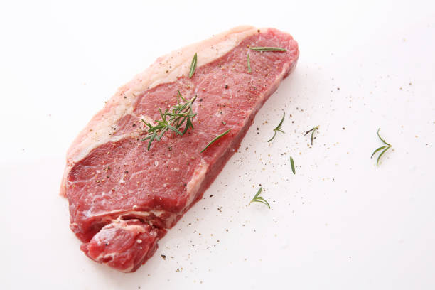 fresh raw beef steak with pepper and rosemary isolated in white background - scotch steak imagens e fotografias de stock