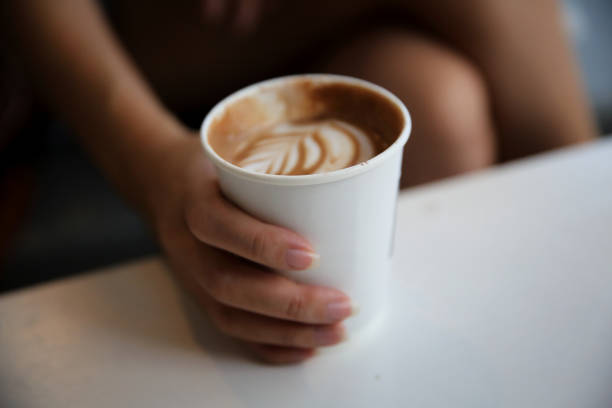 istock cappuccino coffee on woman hand 928504196
