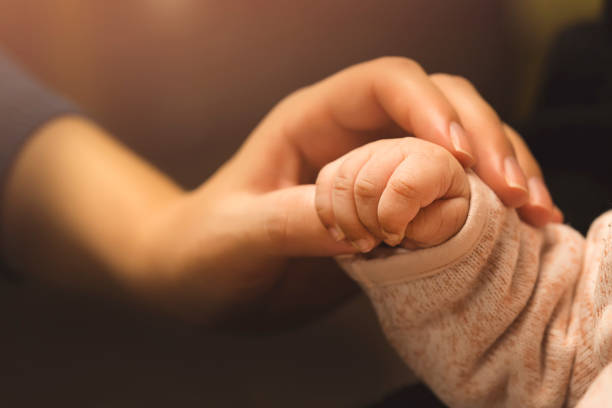 istock Baby Holding Mothers Hand 928504878