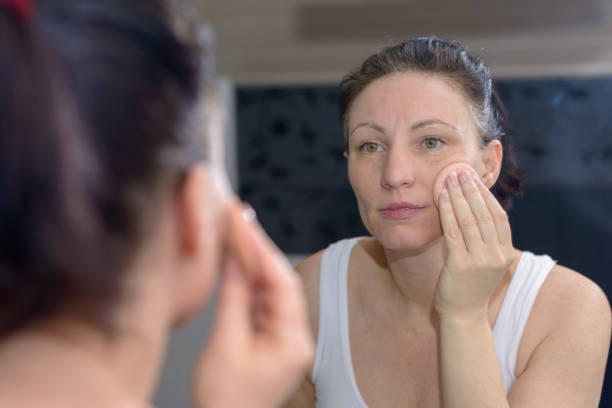 istock Woman using a cotton pad to cleanse her skin 928517778