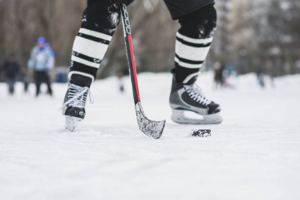 istock hockey player runs with the puck on the ice 928531138