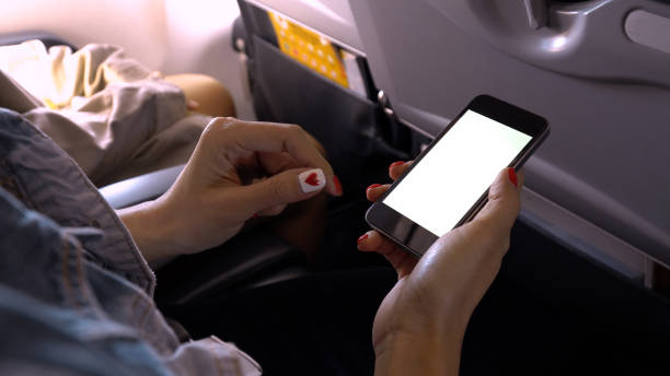 istock touching and slide mobile phone screen on airplane 928531402