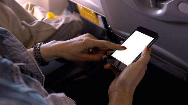 istock touching and slide mobile phone screen on airplane 928531416