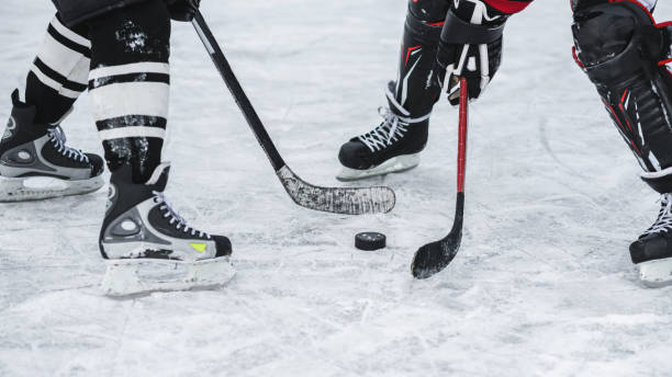 moment in the game when played washer close-up with the puck during the game taking a shot sport photos stock pictures, royalty-free photos & images