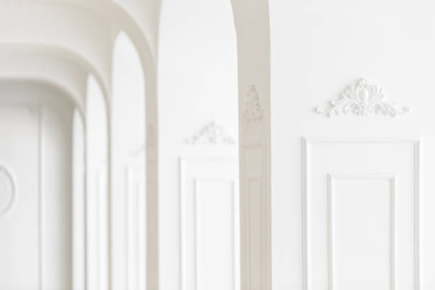 Expensive luxury interior. Stucco elements on line of light columns. White patterned. Mouldings element from gypsum.