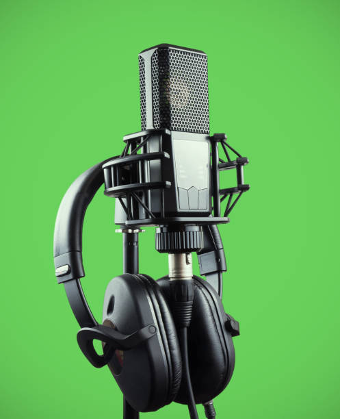 istock Professional microphone and headphones for voice recording on chroma key 928537452