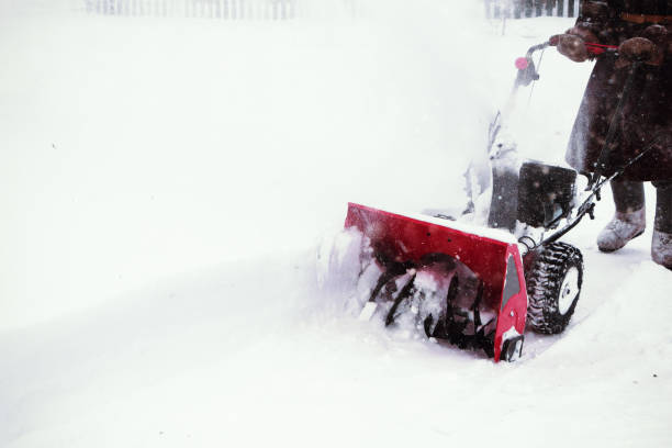 istock Man clears snow with snow blower after winter snowfall 928538308