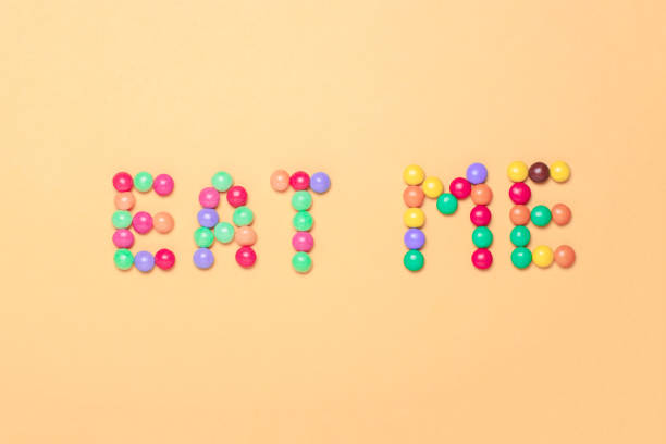 istock text EAT ME written by sweet colorful chocolate candy 928543170