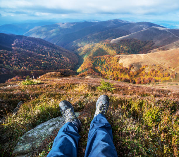 istock Hiker's boots and the mountain peaks. 928546742