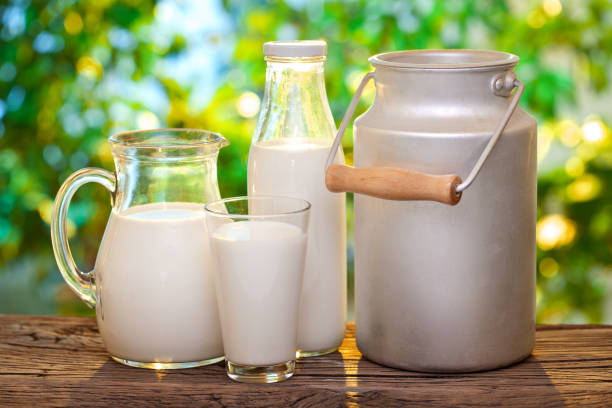 istock Farm milk in different dishes on the wooden table. 928549424