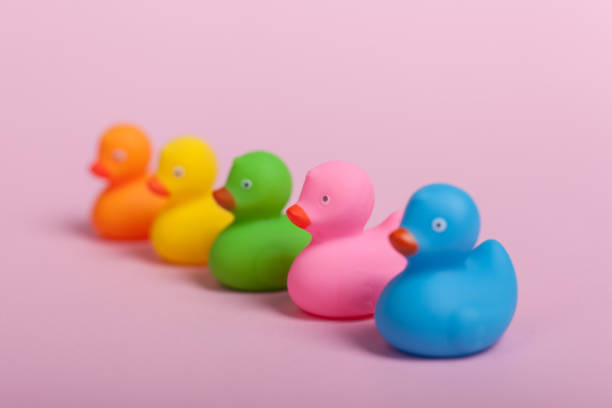 istock colorful rubber ducks on pink background 928549842