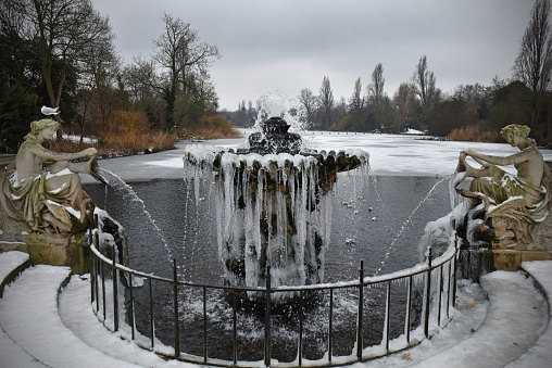 A frozen Victorian ornamental fountain in Hyde Park's Italian garden, London
