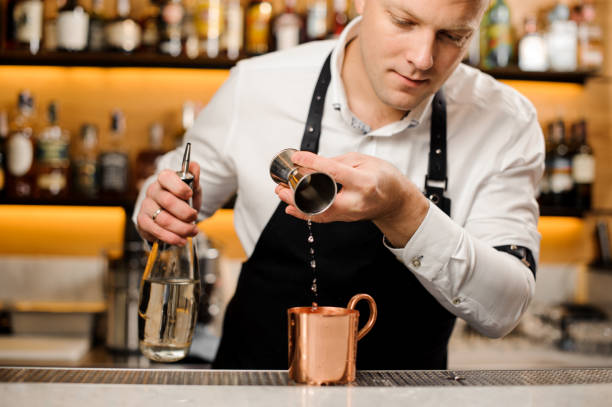 istock Bartender pouring a portion of alcoholic drink into the cup 928550458