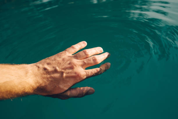istock Male hand in outdoor swimming pool 928553702