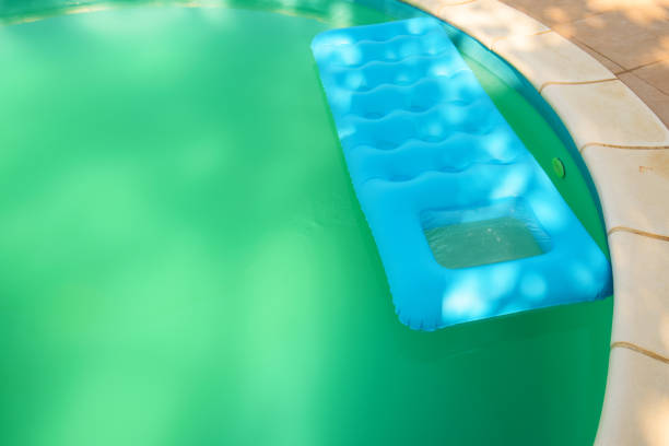 istock Inflatable mattress floating on swimming pool water 928554054