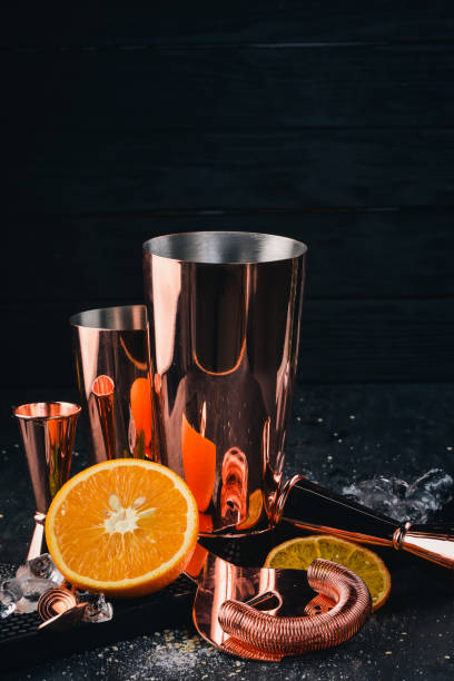 istock Bar cookware. Shaker, measuring glass, streamer. On a black wooden background. 928560356